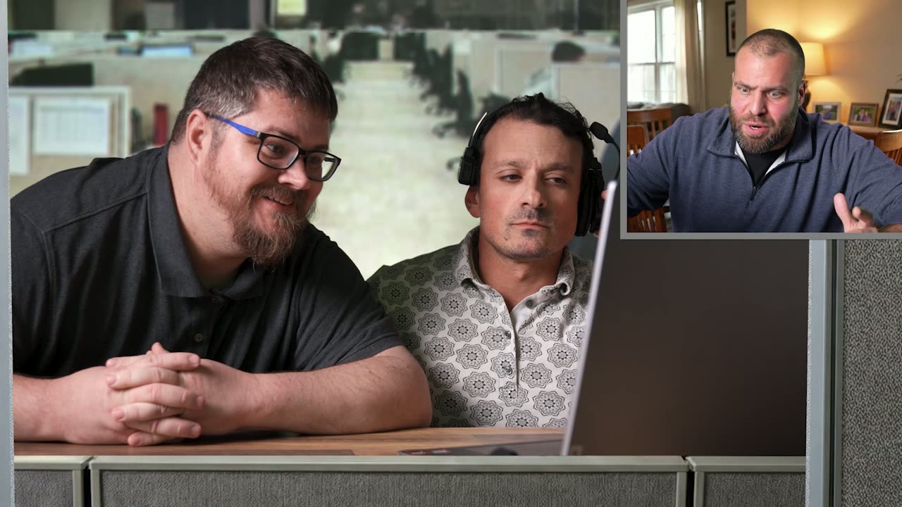 A coworker in glasses leaning in beside the headset tech at the help desk, the caller inset top right