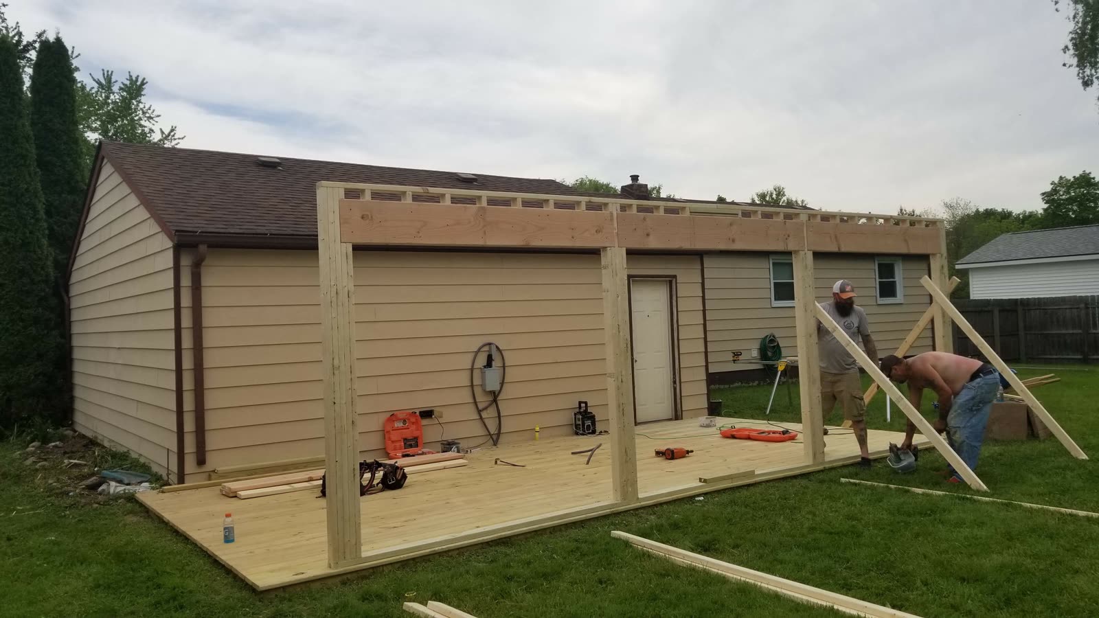 Ground level view of the studio framing, with the long header beam in place across the open front wall