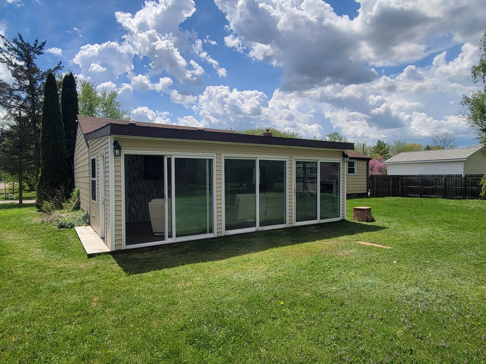 The finished exterior of The Studio Creative's purpose-built studio in Grand Blanc, Michigan, with a wall of sliding glass